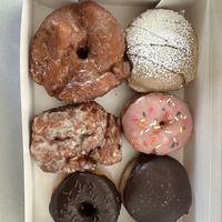 From top left clockwise: vanilla bean glaze, French toast, strawberry frosted, Boston cream, chocolate frosted, apple fritterr #Veganuary at Bitchin Donuts in Albany