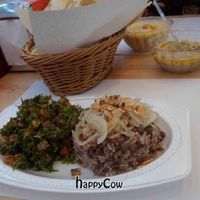 Beans rice with small brown peas, caramelized onions and roasted almonds, side dish salad of choice (shown with tabulleh) at Kebab in Maracaibo