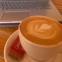 vegan latte with free biscoff biscuit   at Room 76  in Brighton