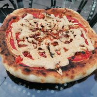 Sausages vegan pizza at PLANTS Kitchen & Bar in Almaty