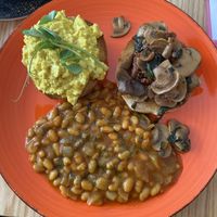 Breakfast muffin with extra masala beans  at Door to the Cosmos in Lowestoft