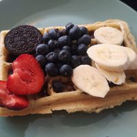 Massive vegan waffles with fruit and chocolate sauce (under fruit) at Zakładka in Bydgoszcz
