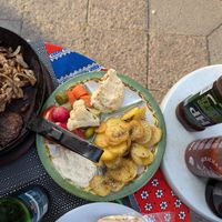 Veggies, potatoes, hummus, baba ganoush that comes with grilled meats at Vegano Mezo in Berlin