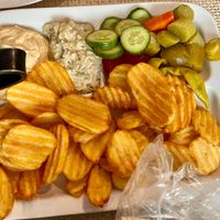 Part of the mixed grilled plate including fried potatoes, vegetables, hummus, and babaganoush/mutabal at Vegano Mezo in Berlin