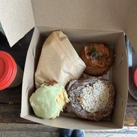 Ham Sandwich (wrapped), Salmon Lox Danish, Double Baked Hazelnut Almond Pain Au Chocolat, Vanilla Bean Scone with Matcha Glaze  at Bad Attitude Bread in Toronto