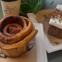 Cinnamon bun and carrot cake, with an oat milk chai latte at Harbour Coffee Co in Folkestone