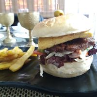 Burger with 2 seitan patties and 1 tofu patty, fresh veg, and house made mayo at Vegan House Cafe & Restaurant  in Lalitpur