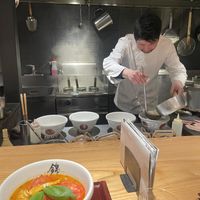 Sitting at the counter  at Ramen Nishiki in Kyoto