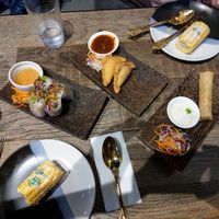 Fresh spring rolls, Curry puffs, Corn cob with coconut butter and Fried spring rolls. at The Diversity Restaurant in Christchurch