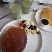 Fruit and vegan pancakes, matcha oat latte at Pop's Pancakes in Brussels
