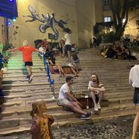 People dining outside on the stairs   at The Food Temple in Lisbon