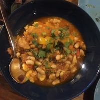 Polenta with coriander and vegetables in a pepper stew with vegan chorizo 😍 at The Food Temple in Lisbon