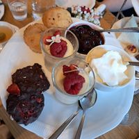 Afternoon tea: muffins with cherry jam and cream, lemon posset and rocky road bites at Ateneum Bistro in Helsinki