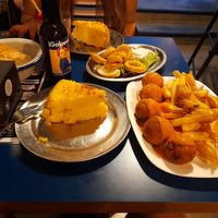 Tortilla de patata, calamares fritos y albóndigas con patatas fritas.  at B13 Bar in Madrid