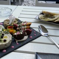 Vegan platter for 4: hoummus, falafel, babaganoush, eggplant tartar & za’atar pita  at Aubergine - Aviatorilor in Bucharest