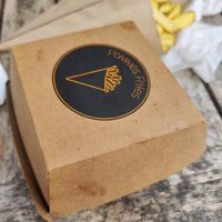 The logo and french fries (background) at Pommes Frites in Roermond