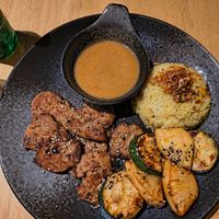 Happy grillteller (vegan meat, rice, homemade sauce, grilled Zucchini and pineapple) at AnTee Vegan in Hamburg