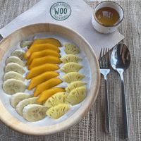 Yellow fruit bowl (granola being removed and cashew yogurt added by a request)  at Woo Phuket in Phuket