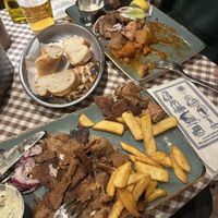 gyros plate with fries and mixed grill plate with greek potatoes (halfway eaten lol)  at Taverna Athene in Berlin