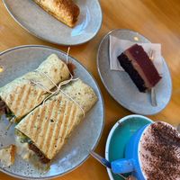 Vegan wrap, sausage roll and cheesecake with oat milk hot chocolate! Straight from the cabinet.  at The Dish Cafe & Bar in Dunedin