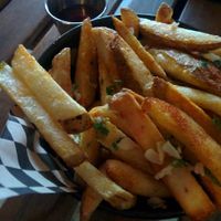 Side of fries, with fresh garlic & parsley at Hella Vegan Eats in Oakland