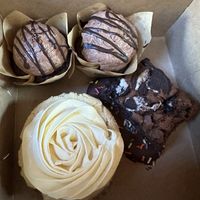 Death by Chocolate Cupcakes, Pineapple treat cookie, Oreo brownie, and a Mickey Chocolate dipped chocolate chip with sprinkles underneath!  at The Caring Kitchen in Rancho Cordova
