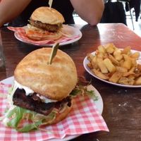 Tofu burger in the front, spicy chickpea burger in the back, with a side order of fries with vegan garlic mayonaise. at Burgertrut in Rotterdam
