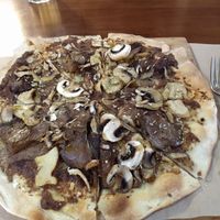 Pizza with mushroom baked in wood oven at Flores do Cabo in Colares