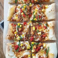 Pizza with vegan cheeze, sweetcorn, tomatoes, onions and jackfruit at Common Meeple Board Game Cafe in Swansea