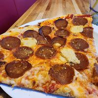 Vegan pepperoni by the slice! The wide angle on my camera makes them seem larger, but they're still a good size. at Pizza Jerk - SW in Portland