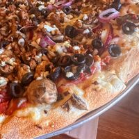 16” vegan pie with spicy tofu, onions, mushrooms, black olives, garlic   at Giovanni's Restaurant and Bar in Mammoth Lakes