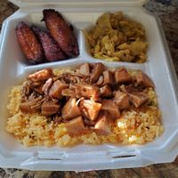 Yellow saffron rice with jerk jackfruit, plantains, and curried cabbage at Afrobites in Little Rock