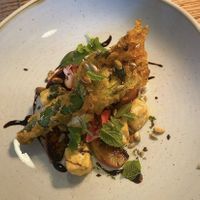 Tofu stuffed fried courgette flower with roasted peach, crispy tofu & seeds   at Lovage  in Newcastle Upon Tyne