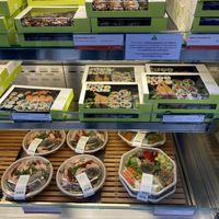 Vegan options on the middle row (clearly differentiated with green vegan labelling)  at Wasabi - Victoria Station in London