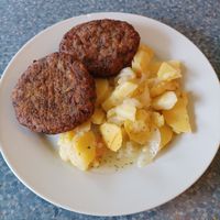 Zelné karbanátky a bramborový salát at Spirala Bio Restaurace in Brno