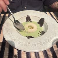 Chocolate ball that comes with a bubble filled with essence you pop at the table! Matcha pour added at the table   at Kroya in Siem Reap