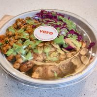 Brown ride base with sweet potato, cauliflower, pickled cabbage and spiced chickpeas and green goddess dressing. at Vero in Belfast