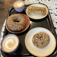 top to bottom: leek and bacon pastry, cream cheese bagel, and chocolate chip cookiees  at Bakery Bakery  - ThreeOfive in Zurich