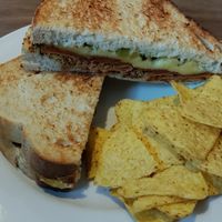 Sandwich with pastrami, cheese, mustard, and pickles at Harry's at 387 in Belfast