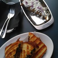 Top: potato omelette topped with aioli and edible flowers. Bottom: grilled toast filled with mushrooms, truffle and melted cheese. at COR in Zurich