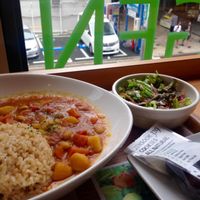 Vegetable curry with salad, and take - away cocoa cookies for later. at Genmai Cafe in Osaka
