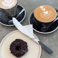 Chai latte, latte macchiato and chocolate doughnut   at Grounded  in El Nido