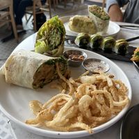 On the plate is half falafel wrap and half spinach and artichoke wrap (we split). Agreed the spinach wrap was the winner.   at Planta - Brentwood in Los Angeles