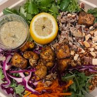 Crispy Rice Warm Bowl: Swap chicken for roasted tofu,  raw carrots, shredded cabbage, cucumbers, cilantro, roasted almonds, crispy rice, warm wild rice, arugula, lime squeeze, spicy cashew dressing. Amazingly delicious! at sweetgreen in Schaumburg