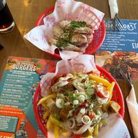 Top: garlic ch*cken strips
Bottom: loaded fries, garlic ch*cken, red peppers, and spring onions. at Junk Soul Smothered Bar & Grill in Beverley
