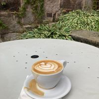 Oat milk latte, on outdoor table. at Revelstoke Coffee in Concord