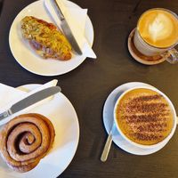 Cinnamon roll, pistachio croissant,  oat flat white and oat cap at The Willows Tea & Coffee House in Todmorden