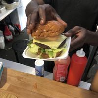 Pictured is the owner assembling the burger   at Fed By Plants in South East London