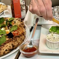 Garden pizza, meat feast pizza, tofish and chips with wrap in background   at Fed By Plants in South East London