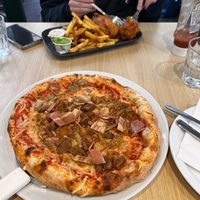 Great sized and great tasting “meat feast” pizza, and their fantastic tofish and chips on the other side of the table. March 2026  at Fed By Plants in South East London